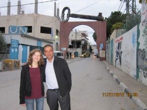 (Emma Bergen stands with Salah Ajarma, a founder of the children’s centre, at the entrance to the refugee camp. On the right, is the wall. Metro/Handout)
